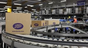 Cardboard boxes in various sizes on a logistics conveyor system at a warehouse for Boots