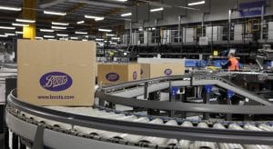 Cardboard boxes in various sizes on a logistics conveyor system at a warehouse for Boots