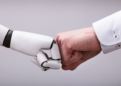 Robot And Human Hand Making Fist Bump Industry 5.0: Humans and technology – the team of the future