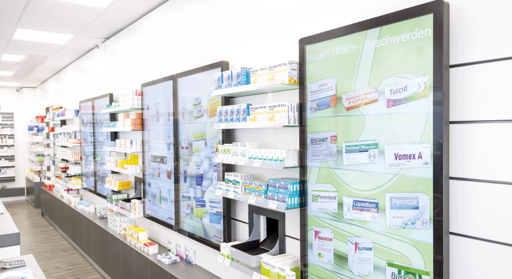 View into the sales area of a pharmacy that is equipped with interactive screens. Here, we offer patients a completely new shopping experience.