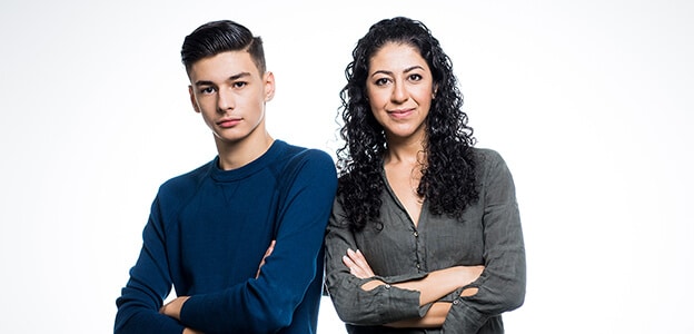 A young man and a young woman are standing next to each other.