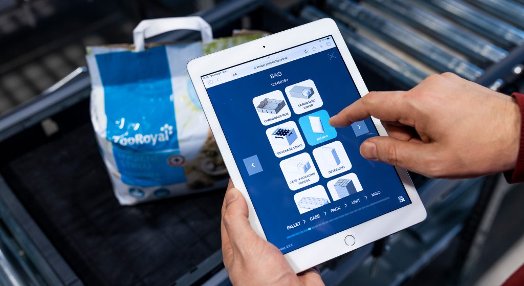 Well maintained master data is essential for automated processes downstream A man is holding a tablet showing the straightforward interface of a software solution for master data recording