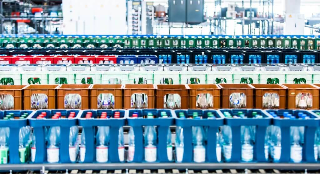 View of colorful empties pallets behind one another in a logistics warehouse