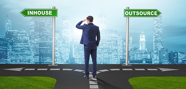 Businessman at crossroads deciding between outsourcing and inhou Insourcing