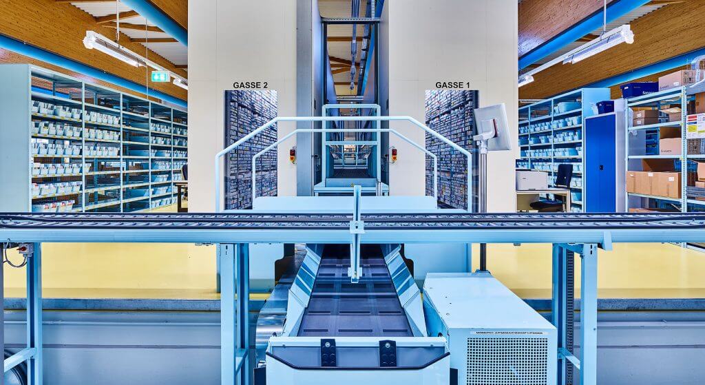 View of a Central Belt System at pharmaceutical wholesaler Sanacorp. A KNAPP-Store is integrated in the central belt system. KNAPP-Store is an automated picking system which stores medicines on a single item basis. The KNAPP-Store is well suited to use in pharmaceutical wholesale and enables seamless traceability and Track & Trace, for example.