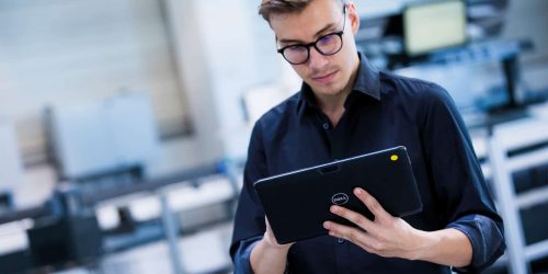 Logistics warehouse worker using a tablet with supply chain software; logistics company;