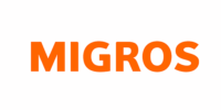 Logo Migros Le mot "MIGROS" est écrit en lettres orange majuscules sur fond blanc lors du salon LogiMAT 2023.