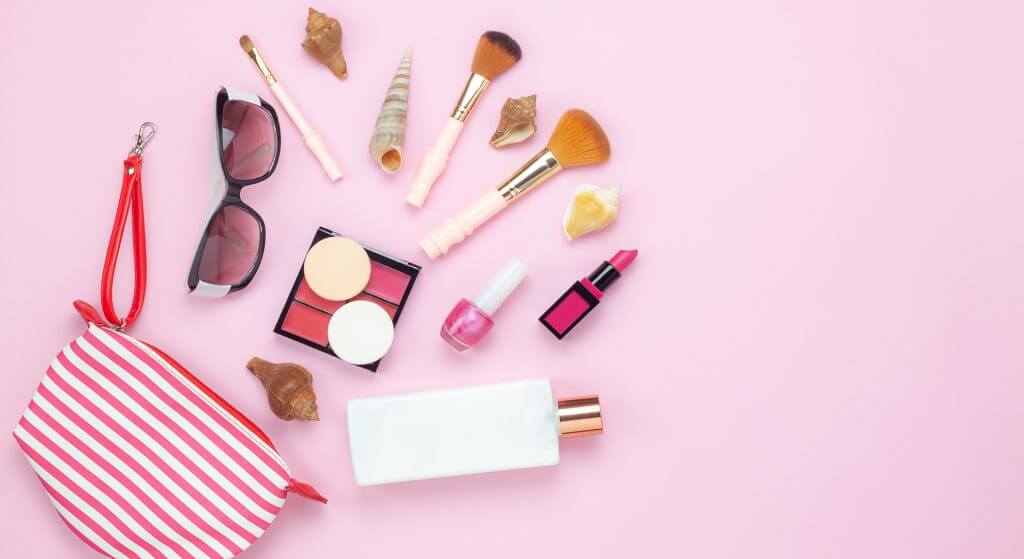 Table top view women fashion & beauty for travel summer holiday background concept.Flat lay accessories objects sun glasses & sun block body lotion on modern rustic pink paper wallpaper and copy space Table top view women fashion & beauty for travel summer