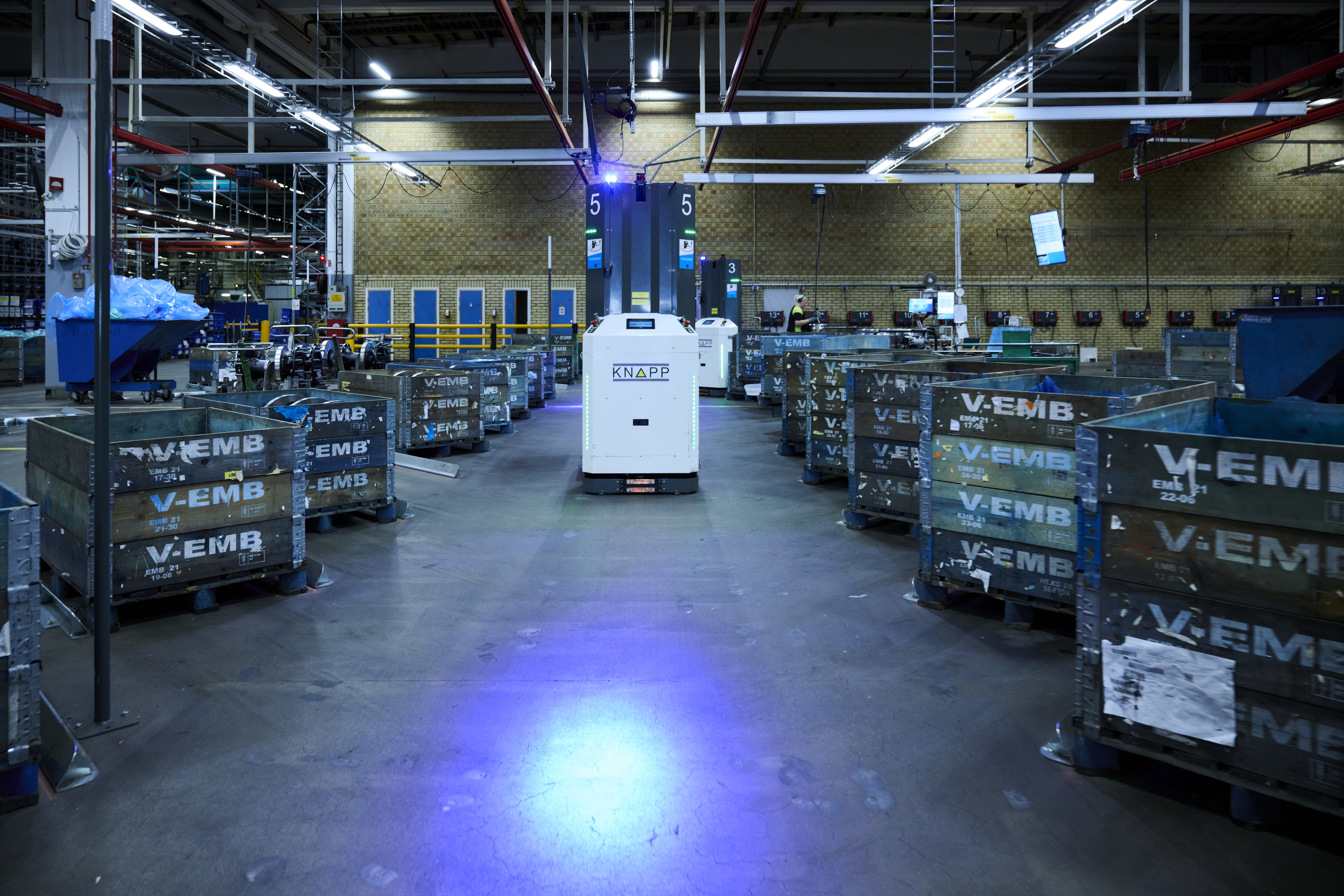 Open Shuttle Fork Palettentransporte bei Cummins Open Shuttle Fork zwischen Paletten mit blue light