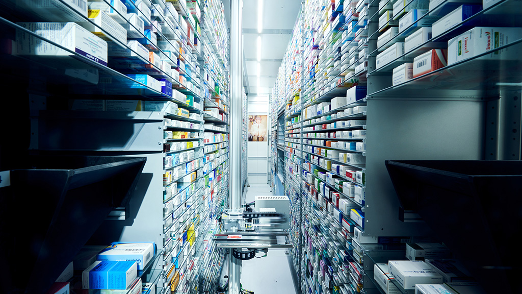 Un sistema de almacenamiento automático de medicamentos con un brazo robótico integrado que almacena y desalmacena mercancía.