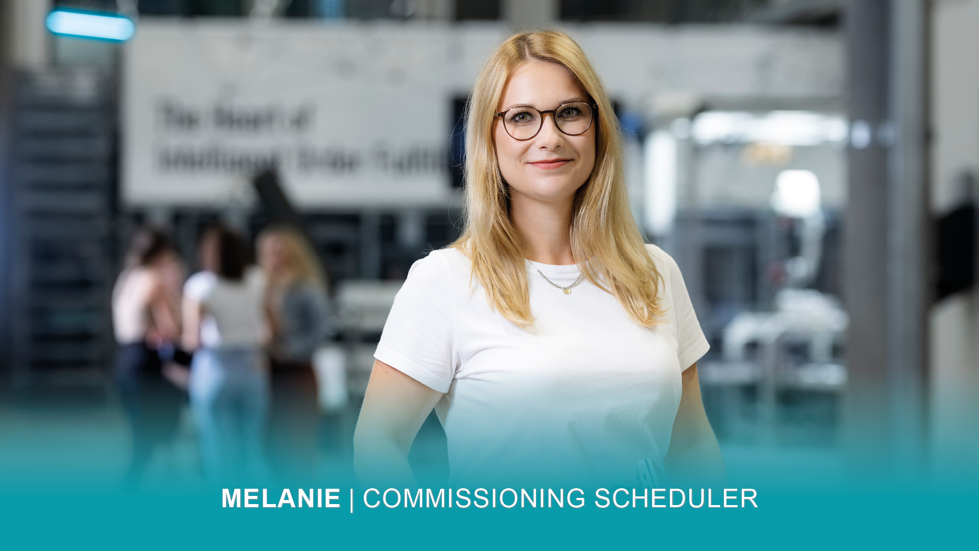 MelanieR_1920x1080 Commissioning Scheduler Melanie hält ihren Laptop unterm Arm und lächelt in die Kamera