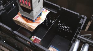 Close-up of the Pick-it-Easy Robot’s arm. The robot is picking food items from a container. 