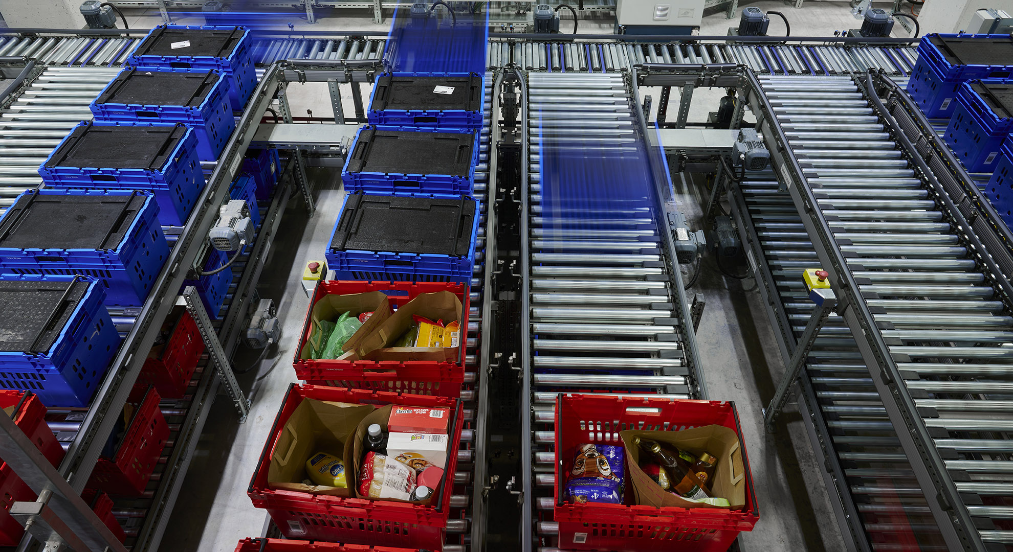 Different order containers with items from all temperature zones at Shufersal. The freezer containers have lids containing cold packs to maintain the cold chain.